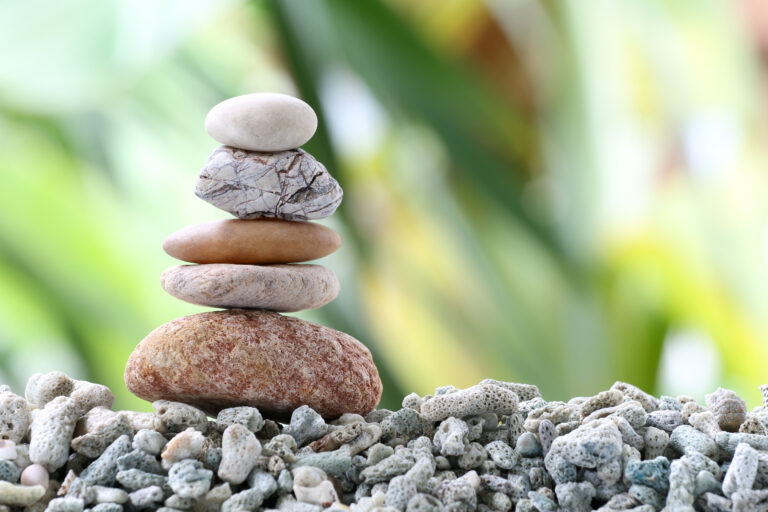 Balance stone on pile rock with garden background