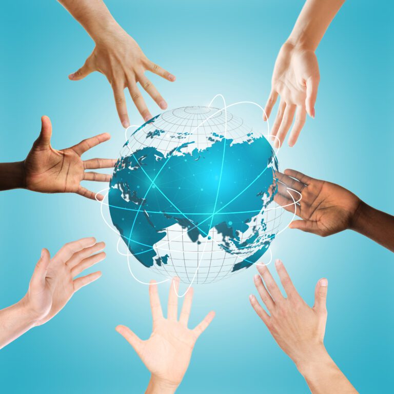 Hands surrounding globe on blue background