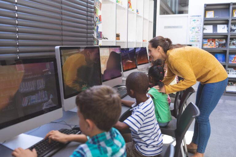 Teacher teaching student in computer room